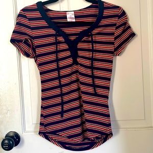 T-shirt the is red,white,blue, and tan colored stripes